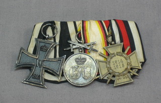 A group of 3 Imperial German medals comprising Iron Cross, The Cross of Honour with cross swords and 1 other