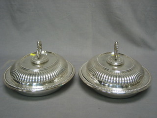 A pair of oval silver plated entree dishes and covers with demi-reeded decoration