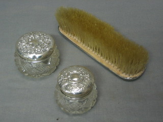 A silver plated hand mirror, 3 dressing table jars with silver lids and a salt bottle