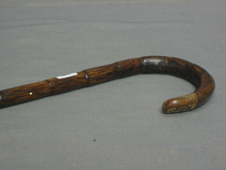 A bamboo walking stick with gilt metal mount, marked Sangster