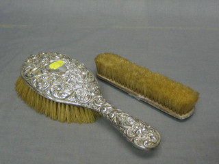 An Edwardian silver backed hairbrush and matching clothes brush Birmingham 1900 and 1901