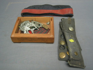 A Cameron Highlanders cap badge, a London Scottish cap badge and a Gordon Highlanders cap badge, a collection of various cloth insignia, an RAF forage cap and a belt with various buttons