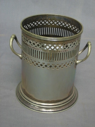 A pierced cylindrical silver plated soda siphon holder