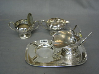 A pair of circular silver plated ashtrays by Mappin & Webb, a silver plated sugar scuttle and a small collection of plated items