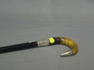 An ebony walking cane with silver band and horn handle