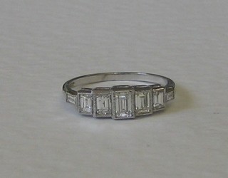 A lady's 18ct white gold 5 stone diamond dress ring set 5 baguette cut diamonds and 2 diamonds to the shoulders - approx 0.85ct