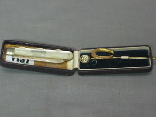 A Victorian silver bladed folding fruit knife with mother of pearl grip together with 2 stick pins