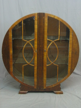 An Art Deco circular mahogany display cabinet enclosed by astragal glazed panelled doors 24"