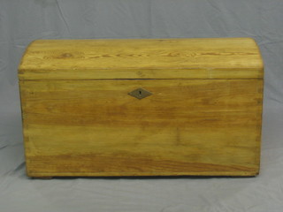 A stripped and polished pine domed trunk with iron handles 38"