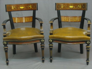 A pair of Italian ebonised and inlaid walnut tub back open arm desk/carver chairs, raised on turned and reeded supports