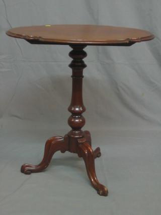 An Edwardian oval walnut wine table, raised on pillar and tripod supports 26"