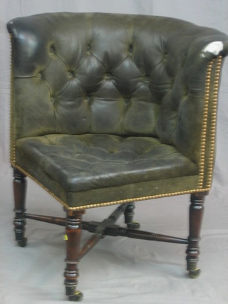 A 19th Century mahogany corner chair upholstered in black buttoned material with X framed stretcher, raised on turned supports
