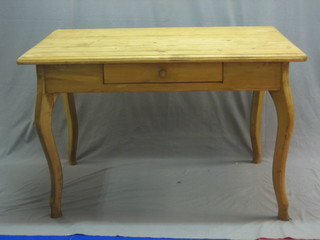 A rectangular  Continental stripped and polished pine table fitted a frieze drawer and raised on cabriole supports 49"