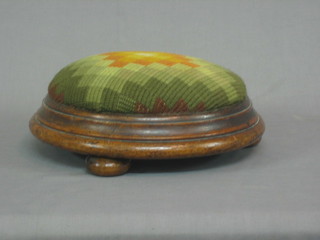 A circular Victorian mahogany footstool raised on 3 bun feet 13"