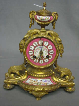 A Victorian French 8 day striking mantel clock contained in a puce and floral porcelain case with gilt ormolu mounts