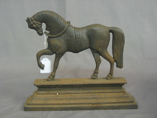 A Victorian cast iron door stop in the form of a walking horse 12"