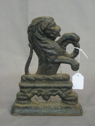 A Victorian cast iron door stop in the form of a rampant lion 6"