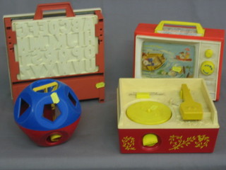 A Fisher Price music box record player, boxed, a Fisher Price Two Tune TV and 2 other toys