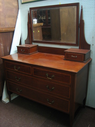 An Edwardian inlaid mahogany dressing chest with swing mirror, the base fitted 2 glove drawers above 2 short and 2 long drawers, raised on square tapering supports 45"