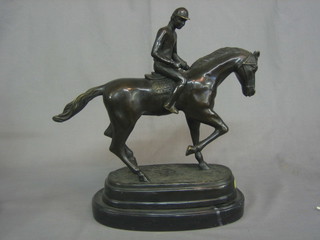 A  modern bronze figure of a race horse with jockey up with oval naturalistic base 13"