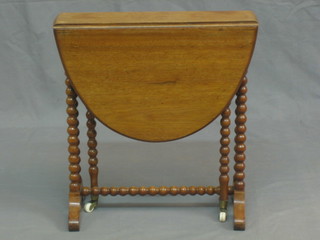 A Victorian oval walnut Sutherland table, raised on bobbin turned supports 19"