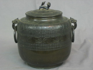 An Oriental bronze twin handled urn and cover with ring drop handles 10"