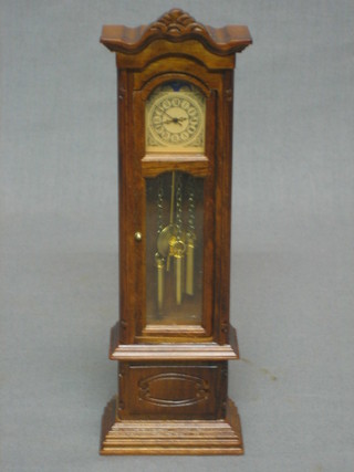A dolls house longcase clock complete with pendulum and weights 7"
