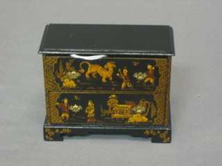 A dolls house black lacquered chinoiserie style chest of 2 drawers, raised on bracket feet 3 1/2" by Judith Dunger