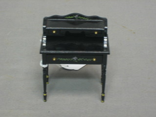 A dolls house Victorian style black lacquered dressing table with three-quarter gallery, fitted 2 short drawers above 1 long drawer 2"