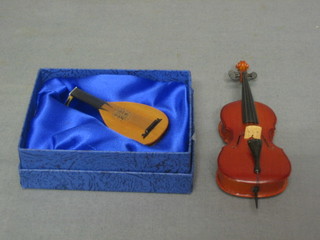 A dolls house mandolin and a cello