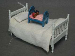 A dolls house double bed 4" together with a childs bed 1"