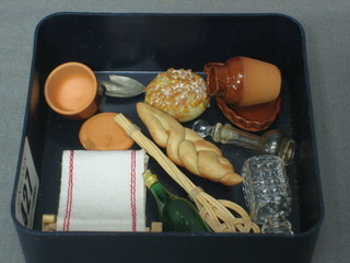 A dolls house roller towel, a carpet beater, 2 gnomes, a garden trowel, a bottle of wine, an oval gilt metal meat platter, an oval pottery flan dish, a jug, cheese dish and cover, spirit decanter and stopper and 1 other decanter