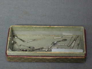 6 dolls house miniature "silver" teaspoons, 6 miniature "silver" knives and forks and a pair of sugar tongs