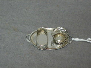 A dolls house silver oval twin handled tea tray together with a circular pierced silver basket and a rectangular dish