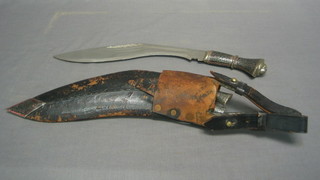 A Kukri with heavily engraved grip, 2 skinning knives and a leather scabbard
