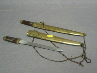2 Eastern daggers with 7" blades contained in a gilt metal scabbards