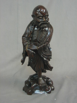 An Eastern carved hardwood figure of a standing sage 15"