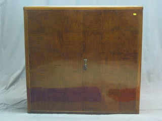 A 1930's Art Deco Eastern hardwood cabinet enclosed by panelled doors 43" 