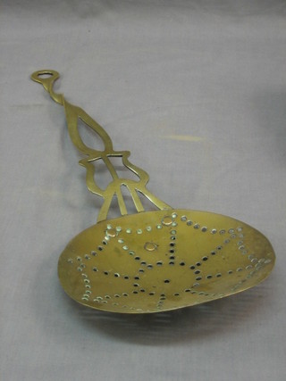 A pierced brass cream skimmer