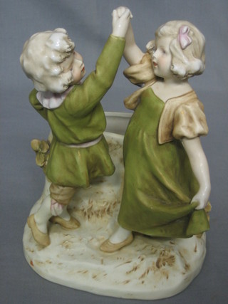 A Royal Dux spill vase supported by 2 figures of a boy and girl 9"