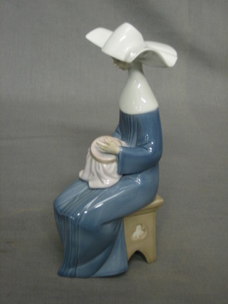 A Lladro figure of a seated sewing nun, base impressed 501 8"