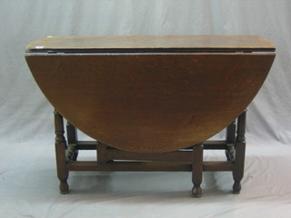 An  18th Century oak oval drop flap gateleg dining table, fitted a drawer and raised on turned supports 42"