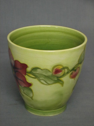 A Moorcroft green glazed cachepot with Clematis pattern, the base with signature mark and impressed Moorcroft Made in England, 4"