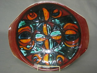 A 1960's Poole oval orange glazed dish, reverse with Dolphin mark 13"