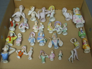 27 various porcelain pin cushion heads and 2 pairs of legs (some damaged)