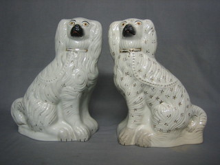 A pair of Staffordshire style figures of seated Spaniels 14"