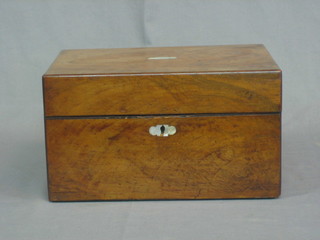 A Victorian walnut vanity box with hinged lid, fitted 10 cut glass bottles, 8 with silver plated tops