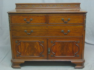 An Edwardian Chippendale style carved mahogany chest of 2 short and 1 long drawers, the base fitted a cupboard enclosed by a panelled door, raised on ogee bracket feet 42"