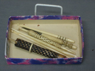 2 ivory needle cases in the form of a parasol 5 1/2", a bodkin with turned ivory handle 4" and 3 ivory crochet hooks