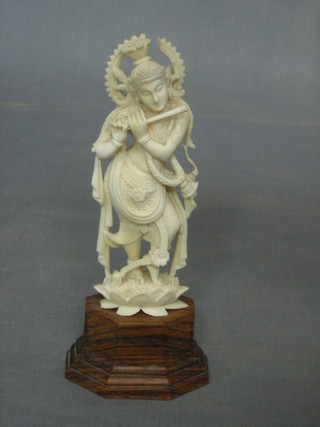 A carved ivory figure of a Deity 5" on a hardwood stand